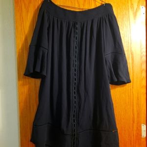 Quarter sleeve black dress with design work on front.